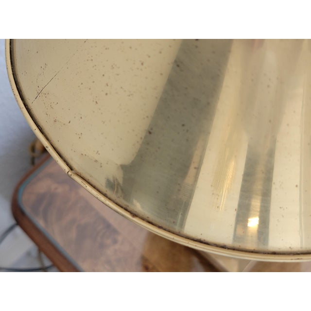 The vintage brass lamps feature an ornate square base with claw or lion's paw feet. They have an adjustable metal shade...