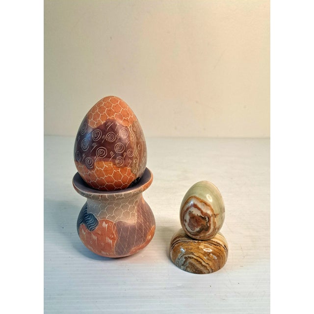 SKU: OT 3388 Vintage Carved Soapstone Egg & Rainbow Stone Egg Set of 2 w/ Stands The larger soapstone egg and pedestal...