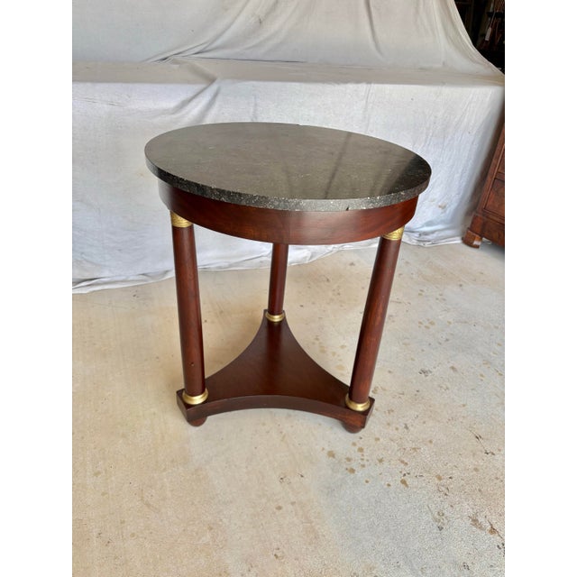 Found in the South of France, this Early 20th Century French Walnut Empire Style Side Table dates back to the early...