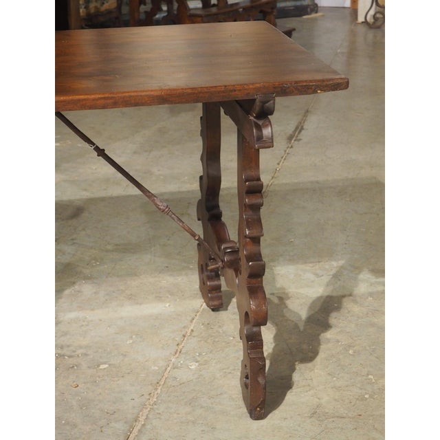 This single plank table with wrought iron stretchers is a wonderful example of Spanish Baroque furniture from the 1700s....