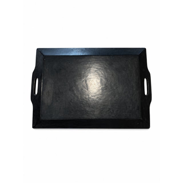 This vintage decorative serving tray features colorful stylized floral and geometric motifs against a matte black ground....