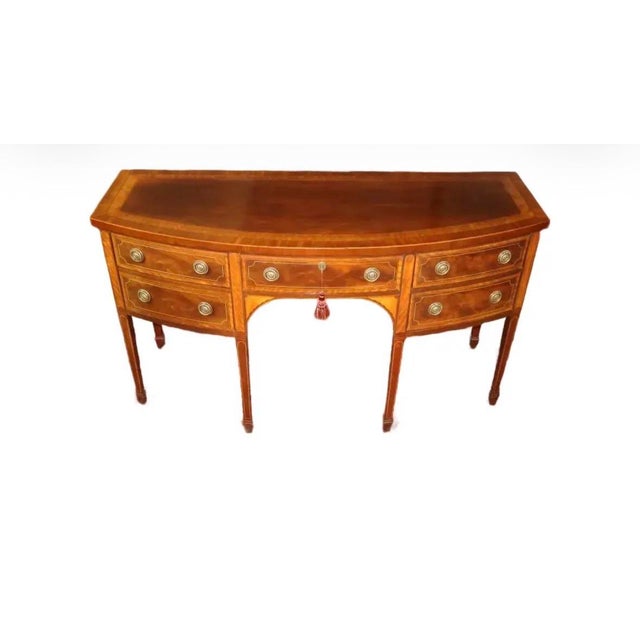 This sideboard is made by Baker Furniture Company for their Historic Charleston Collection. Crafted of mahogany wood with...