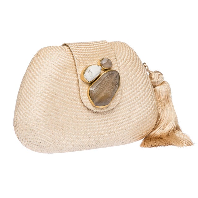 The TAMU Clutch is meticulously handwoven from luminous cream buntal, accented with semi-precious stones set in polished...