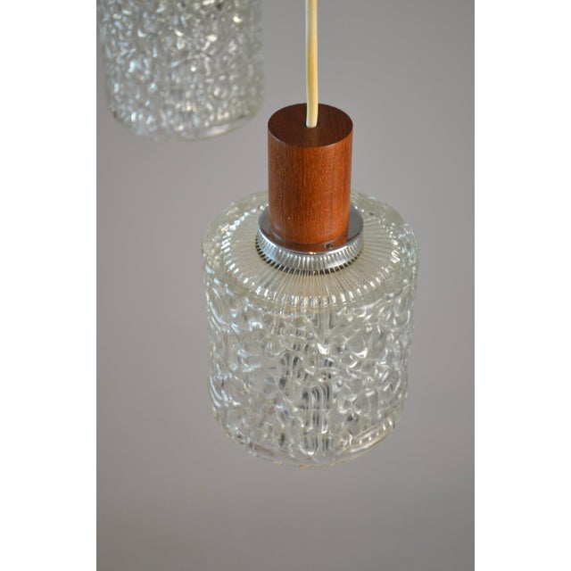 Scandinavian three-light pendant attributed to Danish designer Carl Fagerlund, a key figure in mid-20th-century Nordic...