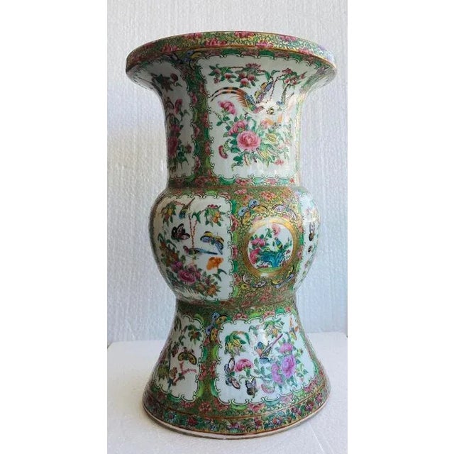 Antique rose medallion vase with a bulbous center section and a smaller flared out section on the bottom and a larger...