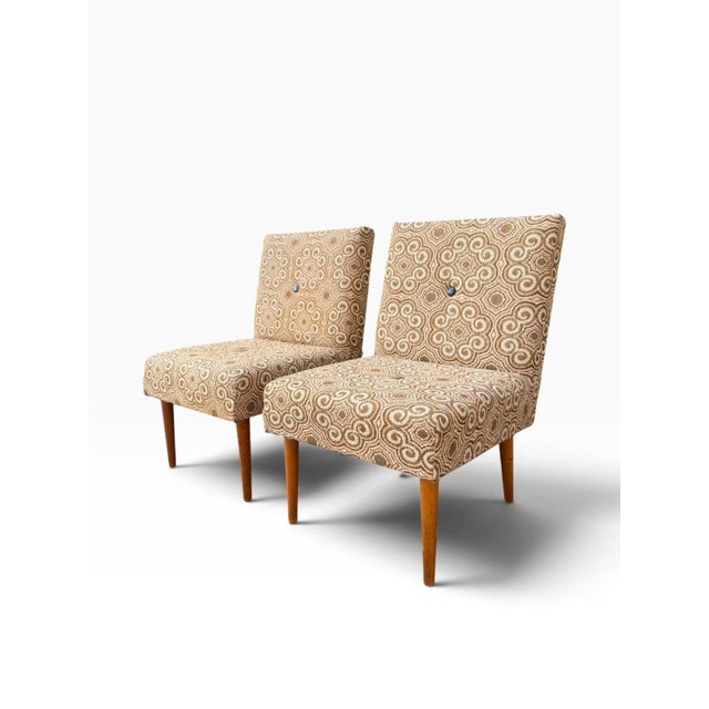 OVERVIEW A pair of mid-century slipper chairs made in Hungary in the 1970s, with their original factory label still under...