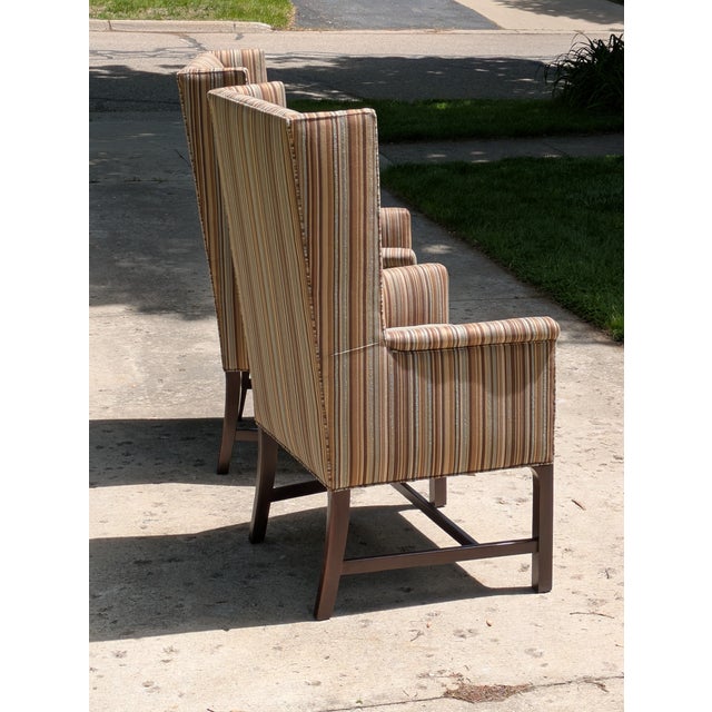 Listed is a very clean line pair of winged back arm chairs. These chairs were made in America by Hickory Chair Furniture....
