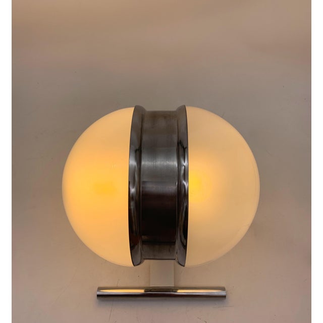 Pair of Space Age style wall lights, featuring a symmetrical and futuristic design. The central structure is made of a...