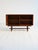 Teak cabinet with tambour door, open compartment with internal shelf, and base with central crosspiece. Scandinavian...