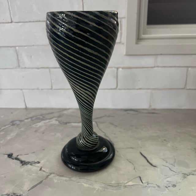 Beautiful midcentury vintage murano style goblet wine glass or vase. Features a black and taupe swirl pattern with a knob...