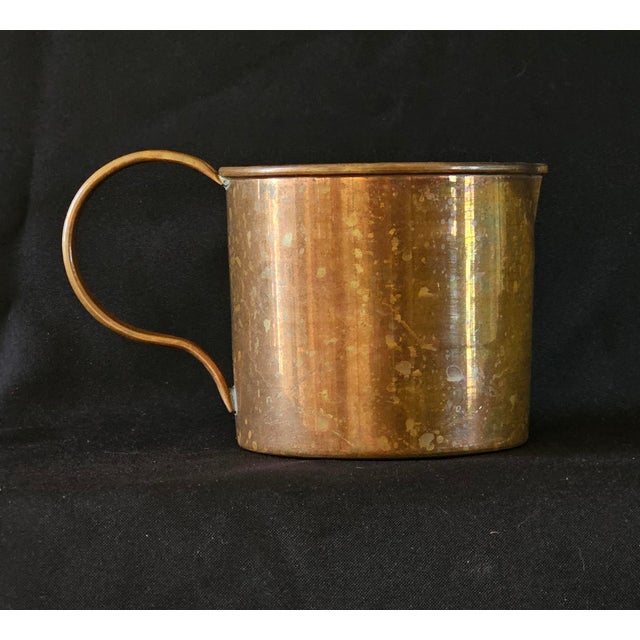 Offered here is a charming antique copper rum cup, reminiscent of the traditional measuring mugs used aboard British naval...