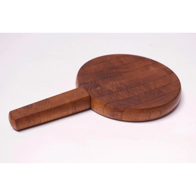 Circa 1960s Jens Quistgaard for Dansk Designs Denmark cheese cutting board with integrated knife in staved teak. An...