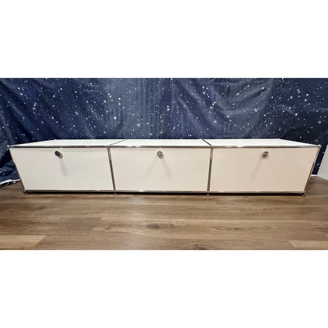 Classic USM Haller storage credenza with three drop down doors that lock with the twist of a coin. This piece offers...