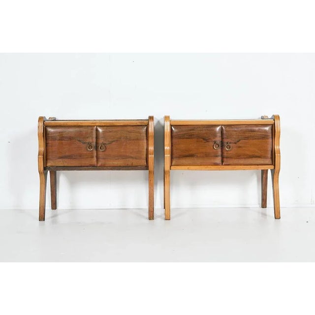 Italian modern set of 2 walnut veneer small storage cabinets/nightstands from 1950’s. It features a glas inlay top with...