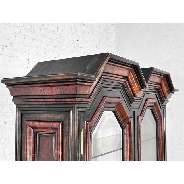 Baroque and Rococo style marquetry bookcase or display cabinet in wood and glass, composed of two sections: The upper...