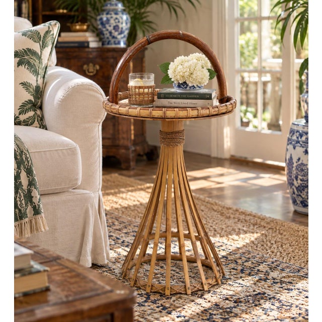 A particularly charming mid-century bamboo and rattan occasional table, distinguished by its oversized bent-bamboo...
