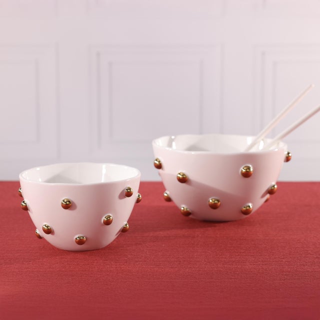 This porcelain bowl brings understated celestial elegance to your table, finished with delicate gold beaded accents that...