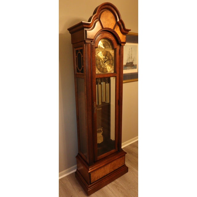An exceptional and increasingly difficult-to-find Howard Miller 610-199 grandfather clock, crafted in the United States...