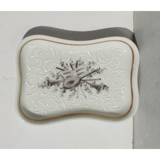 A Porcelain pin tray for the home with the hallmarks of Bonwitt Teller Made in France and a character and gold leaf mark....
