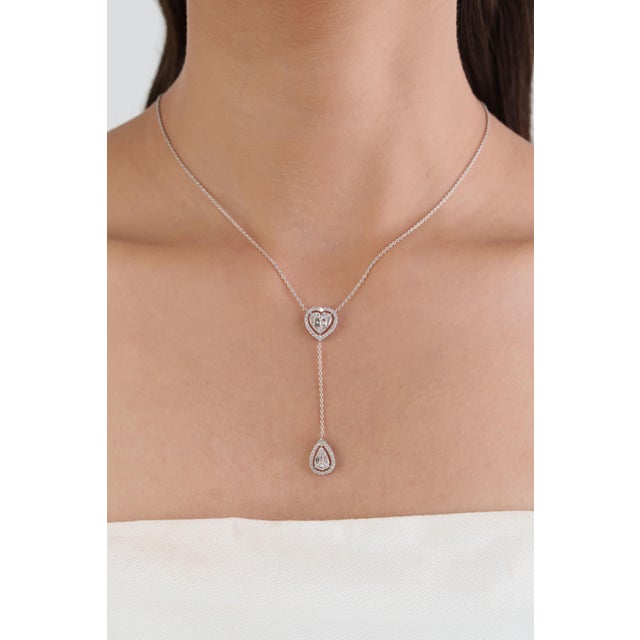 This Halo Heart & Teardrop Lariat Necklace features 0.83 carats of natural diamond, set in 14K white gold. All mixed sizes...