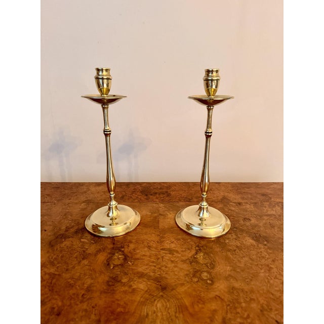 Quality pair of slender antique brass candlesticks, having a pair of good quality slender candlesticks with drip trays,...