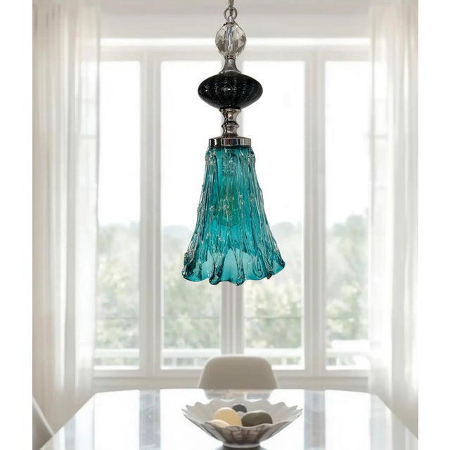 This one‑of‑a‑kind art glass pendant light is a sculptural statement piece that unites cut crystal, hand‑blown glass, and...