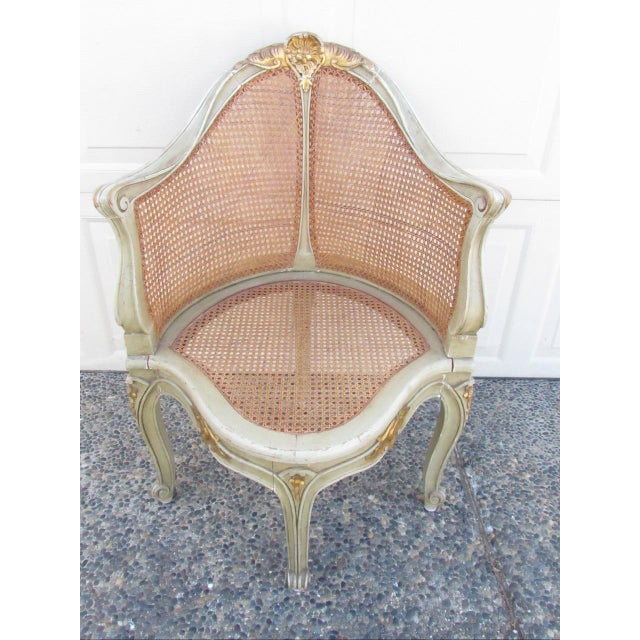 Antique French Louis XV style painted corner arm chair, c.1910 Featuring a caned barrel back, in distressed pale green...