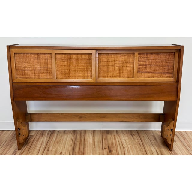Vintage MCM full size headboard featuring sliding cubby doors with caned fronts. Solid wood. Mounting holes are included...