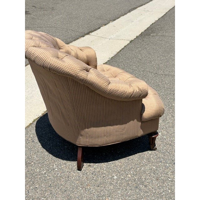 Vintage Tufted English Club Chair on Casters Classic English club chair featuring deep button tufting, gracefully rolled...