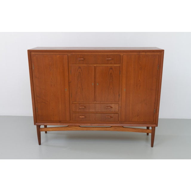 Danish Modern Teak Sideboard, 1950s. Large Danish Mid-Century Modern sideboard in teak made in Denmark in the 1950s. This...