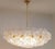 A dramatic oversized pair of Italian Loto chandeliers, circa 1970s, composed of layered textured clear Murano glass discs...