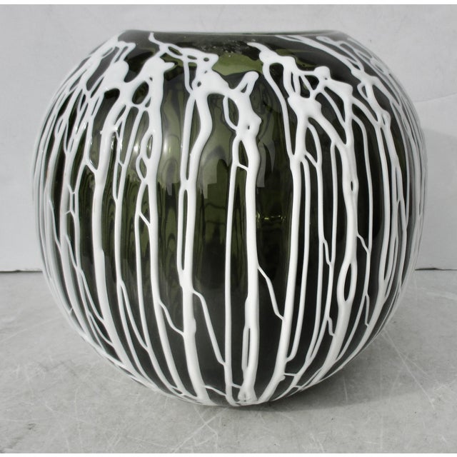 Dark green glass with handmade white tendrils of white glass trailing down the sides, very Viney and botanical in feel,...