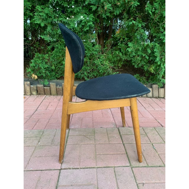 Clean-lined and quietly elegant, this unmarked mid-century modern dining side chair captures the understated...