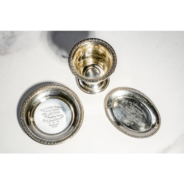 Discovered as a remarkable surviving group, this rare collection of sterling silver military presentation pieces offers a...