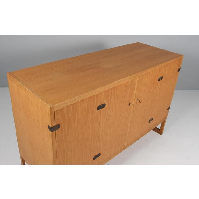 Oak sideboard model "BM 57" with sled base by Børge Mogensen 1914-1972. Two folding doors enclosing oak pullout trays and...