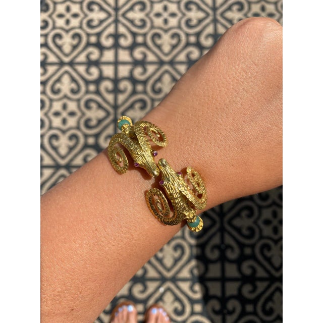 The Angelica Beautifully crafted bracelet by designer Zolotas features two kissing ram heads embellished with ruby eyes...