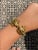 The Angelica Beautifully crafted bracelet by designer Zolotas features two kissing ram heads embellished with ruby eyes...