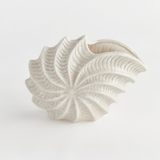 With an antique subtle crackle glaze, this generously scaled shell vase is a stunning accent. Whether on a side table,...
