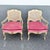 A charming pair of vintage French Provincial armchairs featuring cream-painted wood frames accented with gold detailing....