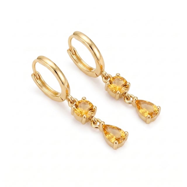 Infuse your jewelry collection with the radiant, sun-kissed warmth of brilliant golden yellow. These striking dangle...