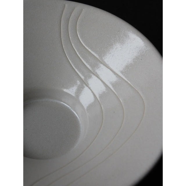 Decorative ceramic wide bowl with wave decor, designed in 1960s by Ingegärd Burmeister for Gabriel Keramik. This piece has...