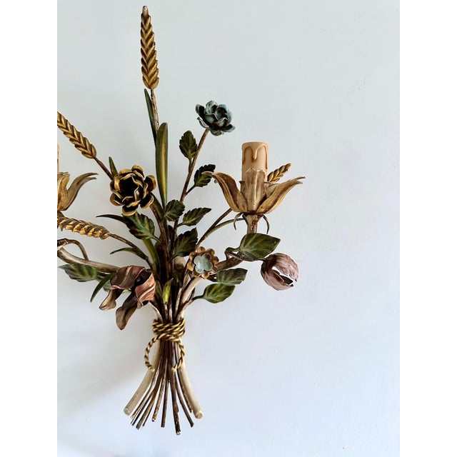 Italian two-light floral wall sconce, circa 1940s, crafted from hand-formed and hand-painted metal. Designed as a tied...