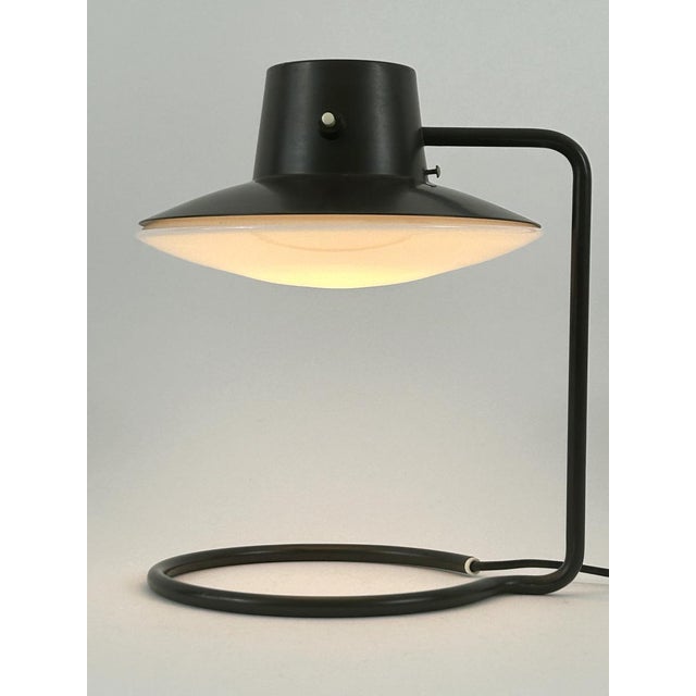Extremely rare early edition and elegant mid-century modern 'oxford' table lamp or desk light in dark brown color....