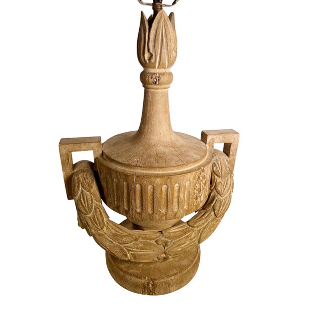A striking pair of Italian style carved wood table lamps featuring a classical neoclassical form with beautifully carved...