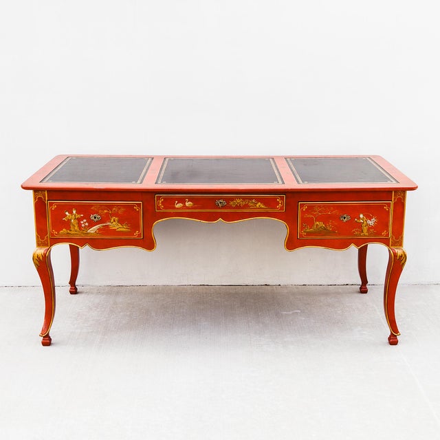 Vintage Louis XV style Chinoiserie writing desk or vanity by Baker in cinnabar lacquer with hand-painted gilt depicting...