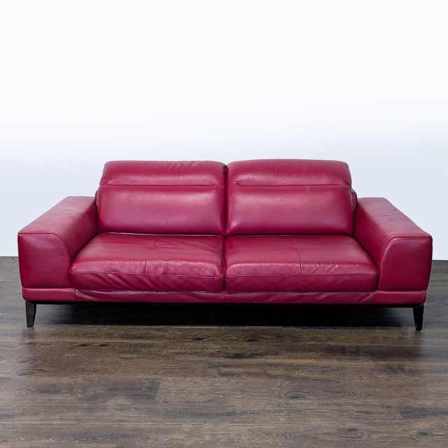 This stylish 3-seat sofa features luxurious red leather upholstery and supportive padded backrests. Its wide armrests and...