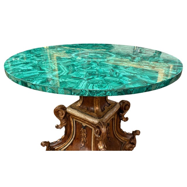 A remarkable late-19th-century Italian center table combining an elaborately hand-carved sculptural wood pedestal with a...