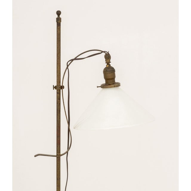 Arts and Crafts Style Bronzed Wrought Iron Floor Lamp, with milk glass shade on tripod base. 55" H x 19" W x 13" D....