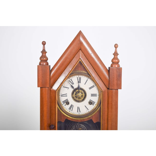 This elegant mahogany chapel clock, crafted by the renowned Waterbury Clock Co. in the USA, embodies the refined...