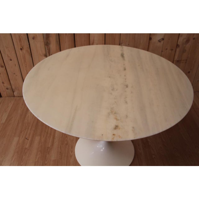 Knoll Tulip Table by Eero Saarinen. 107 cm round Calacatta marble top. Cast iron base with Rilsan coating. Stamped under...